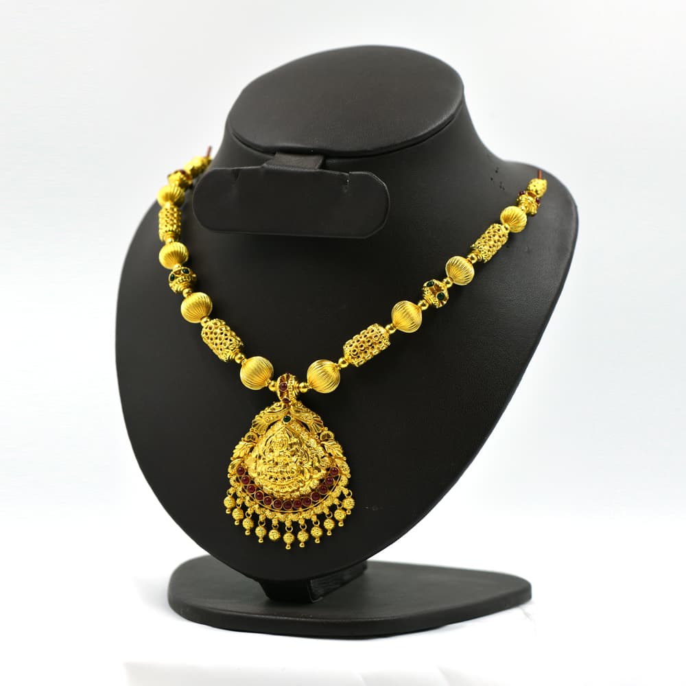 exquisite nagas gold necklace with ornate pendant and red accents