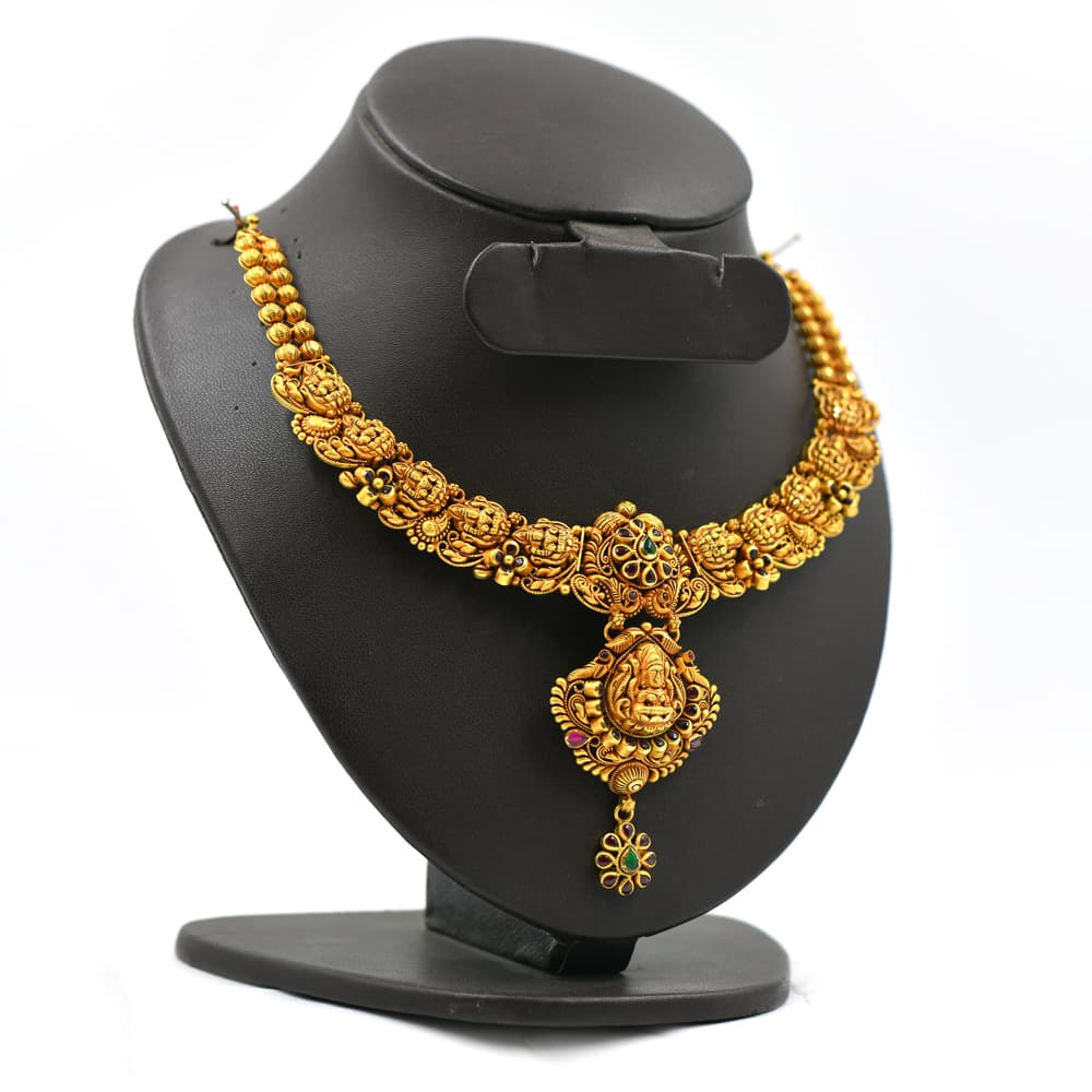 traditional gold necklace with intricate temple design